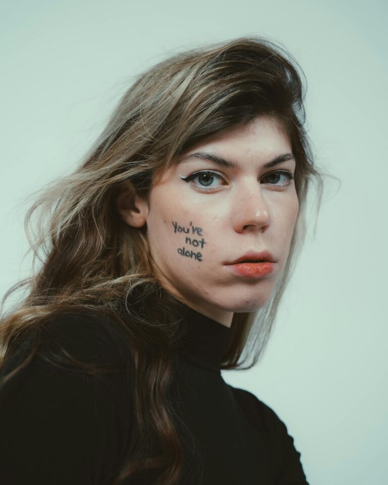 Close-up portrait highlighting mental health awareness with 'You're not alone' message.